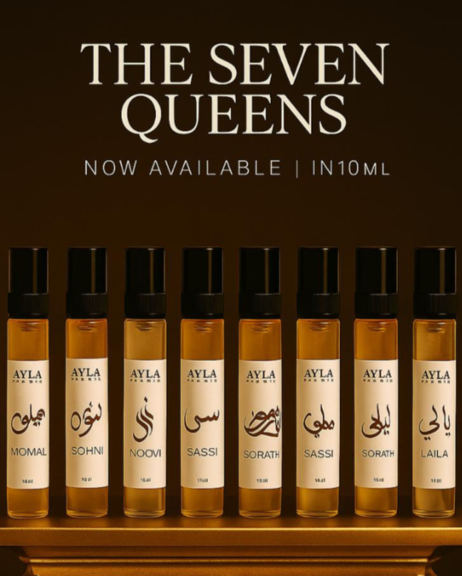 Ayla Studio perfume bottles on a decorative stand with 'The Seven Queens' text on a dark background